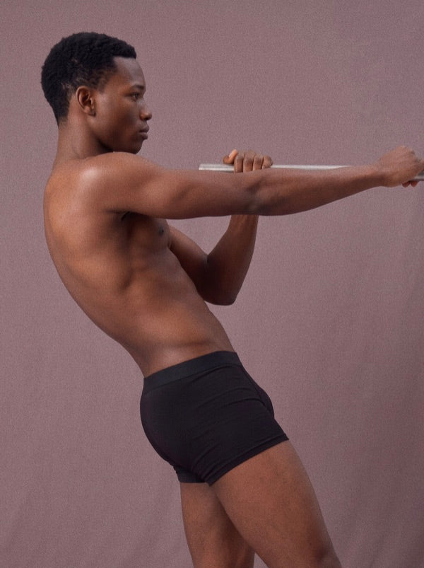 Side view of black Frame underwear during a stretch