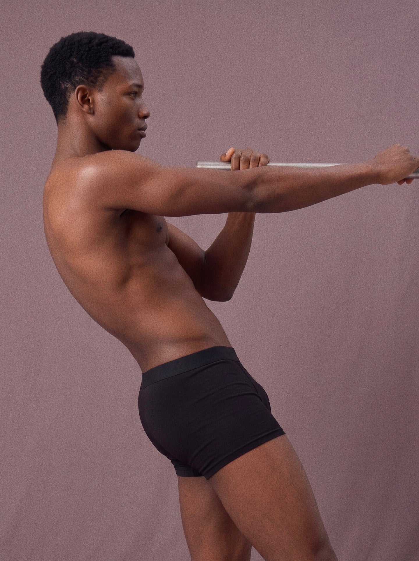 Side view of black Frame underwear during a stretch