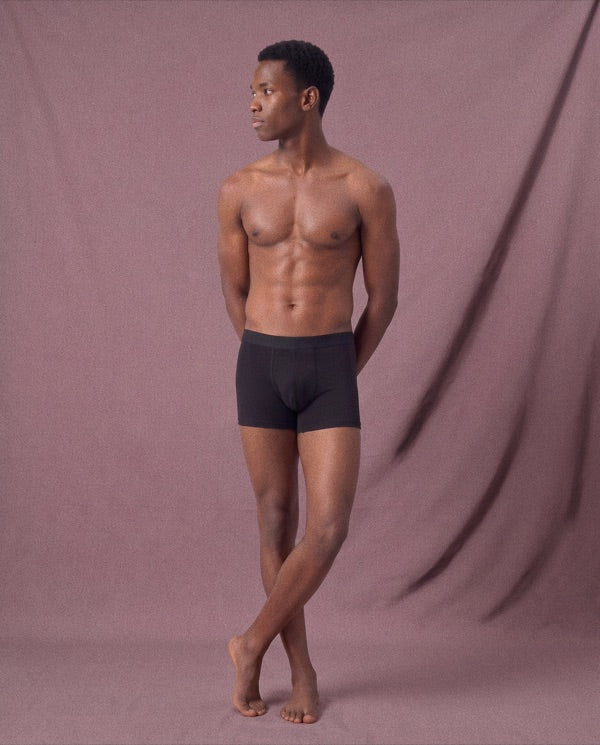 Full-length model wearing black Frame underwear